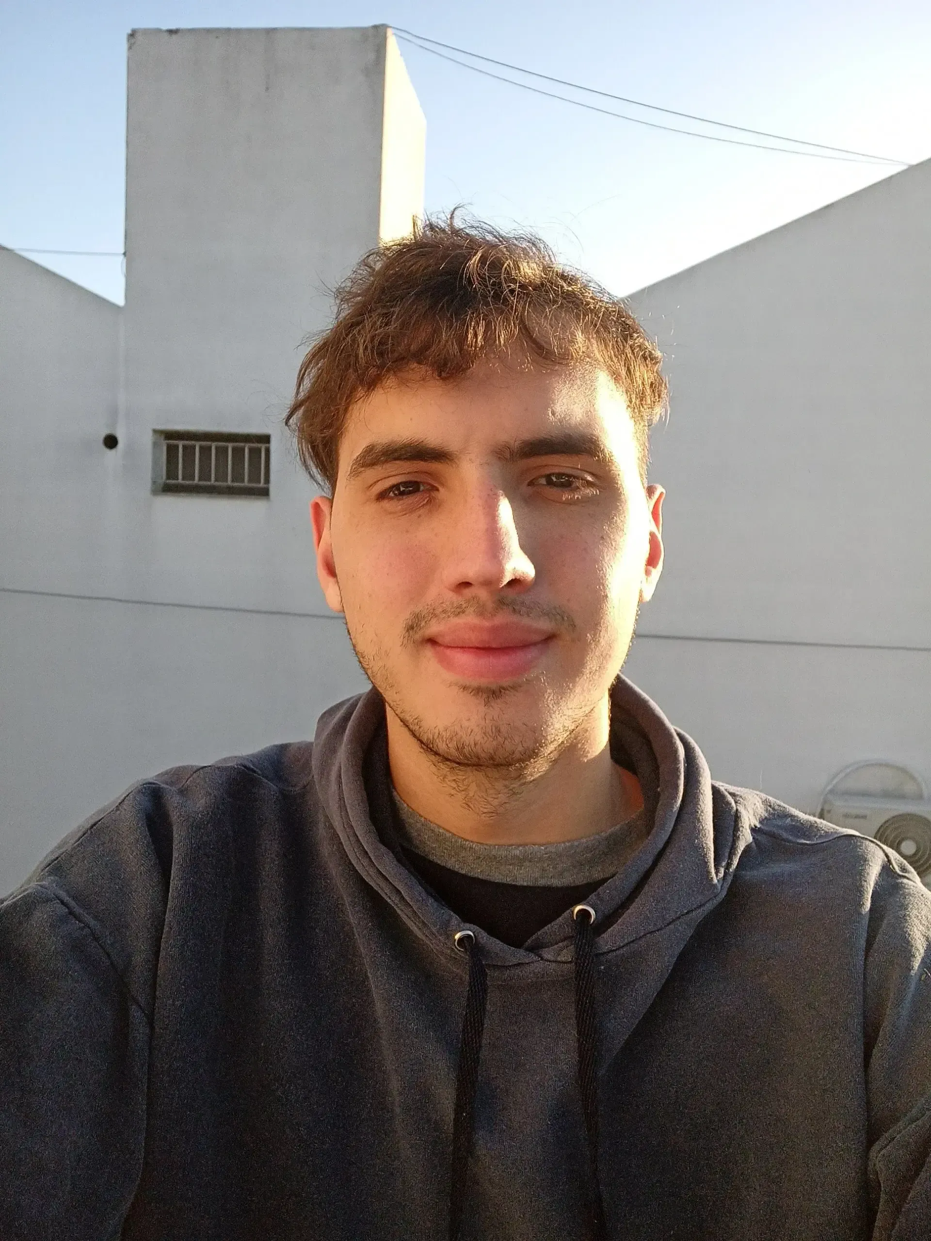 Portrait photograph of Juan Cruz Stakys, a professional headshot against a neutral background with warm, approachable lighting
